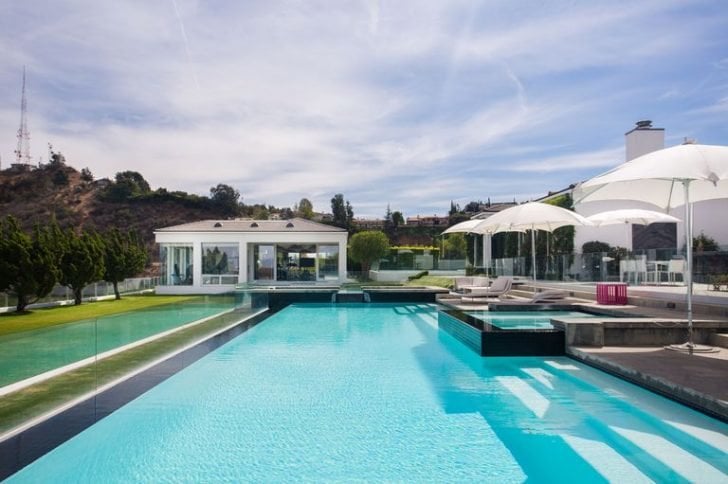 The full sized tennis court and infinity pool are the highlights of this expansive property.