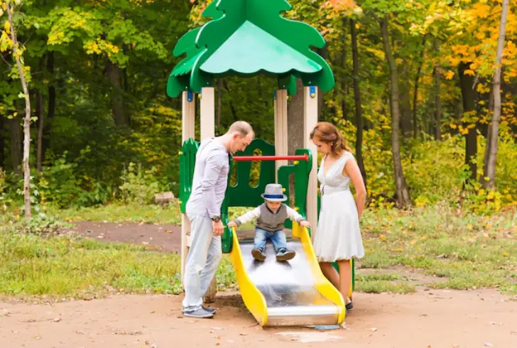 Boy pauses before big slide