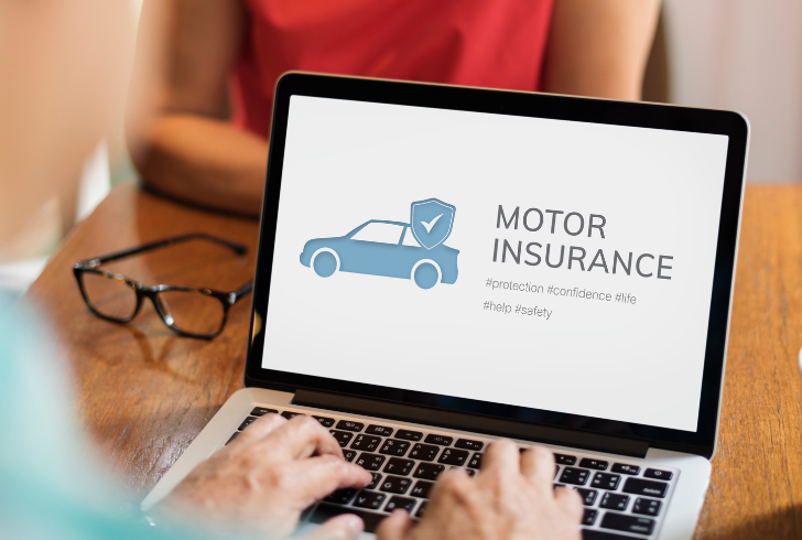 Person searching car insurance on laptop