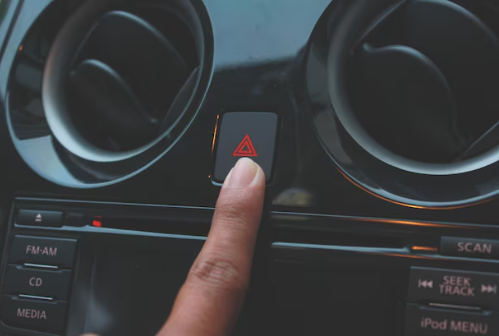 Person turning on car hazard lights